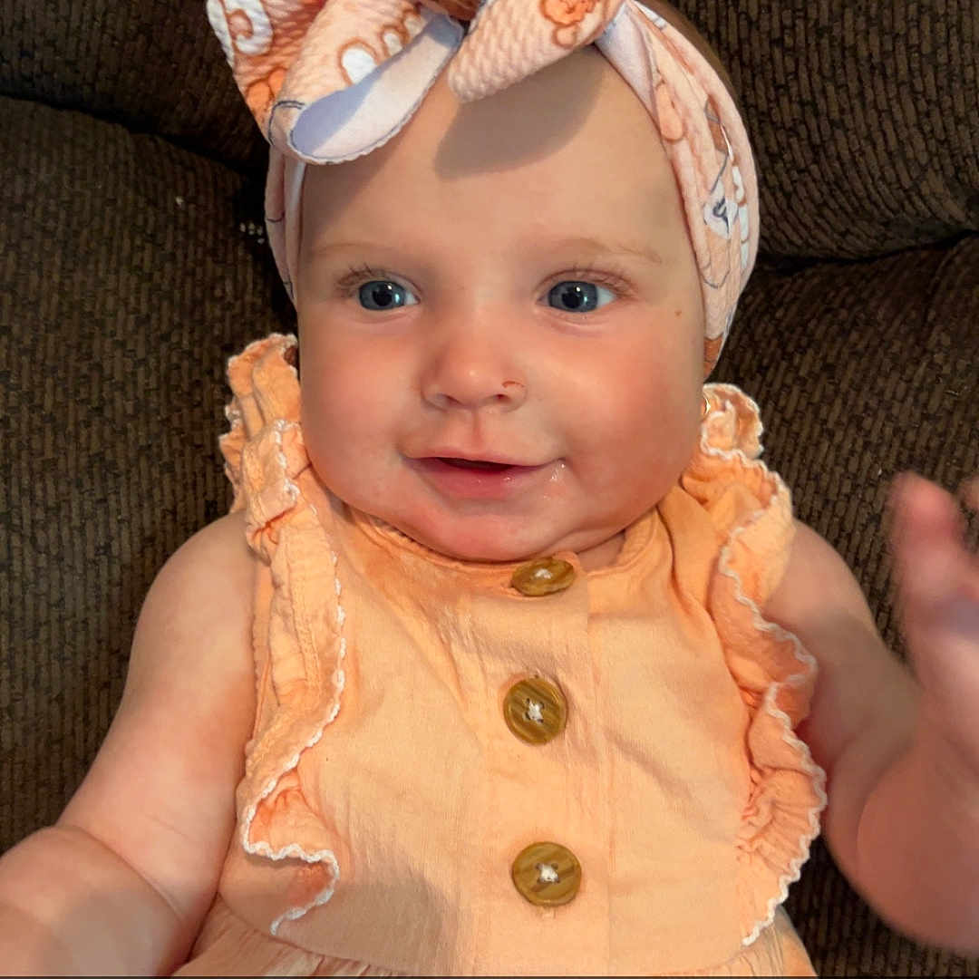 Emerson-Blake joined the competition — help win amazing prizes! accessories, baby, bodypart, bonnet, cap, clothing, couch, dress, face, finger, furniture, hand, hat, head, newborn, person, photography, portrait, sitting, sunhat