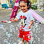 Anand is registered to the contest to win money with this photo: toddler, child, girl, smiling, bubbles, playground, slide, swing, red_bow, minnie_mouse, red_shorts, white_shirt, curly_hair, outdoor, play, fun, happy, feet, shoes, daylight