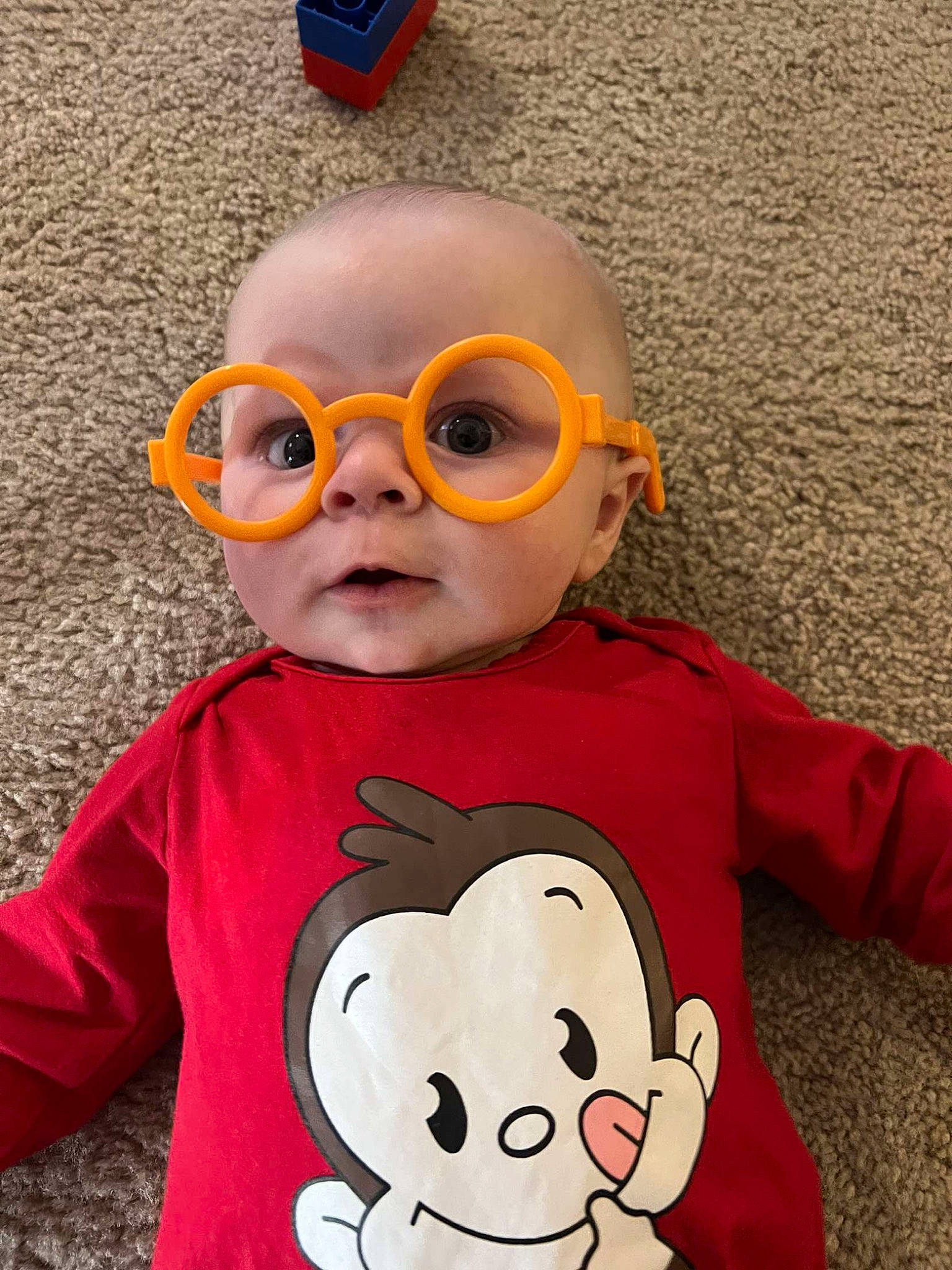 Bentlee joined the competition — help win amazing prizes! baby, baby_toddler_clothing, child, cool, costume, eyewear, facial_expression, fun, happy, head, mouth, nose, orange, person, personal_protective_equipment, red, sleeve, t_shirt, toddler, vision_care