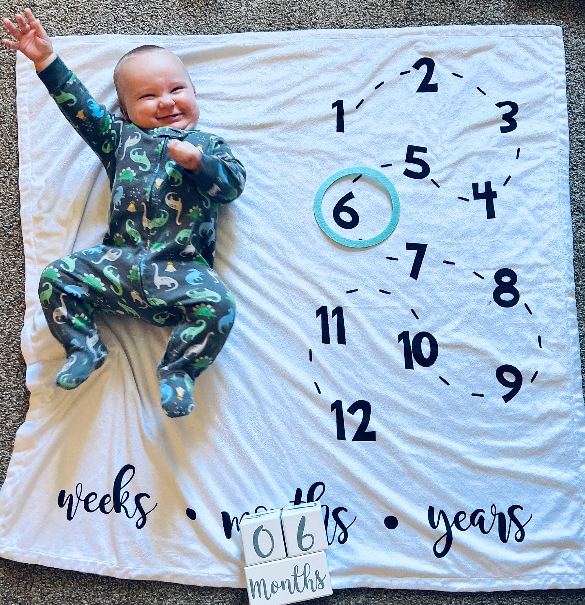 Creed is registered to the contest to win money with this photo: advertising, baby, baby_toddler_clothing, banner, child, flooring, font, happy, joy, leisure, logo, pattern, person, rectangle, sleeve, smile, t_shirt, toddler, visual_arts
