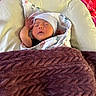 Luka joined the competition — help win amazing prizes! newborn, baby, sleeping, blanket, hat, pillow, cushion, purple_blanket, face, infant, cozy, resting, indoors, soft_texture, child, person, comfort, peaceful, wrapped, controller