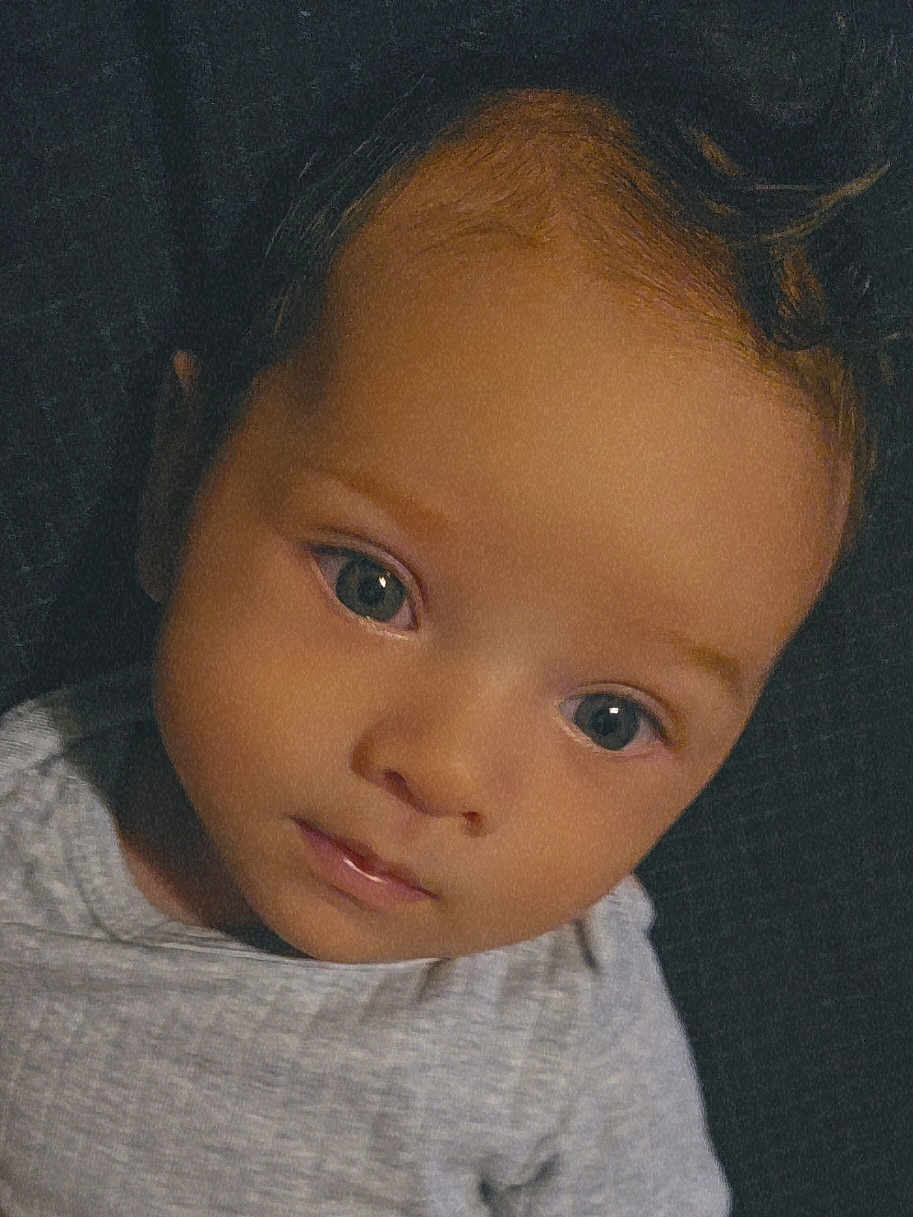 Henry joined the competition — help win amazing prizes! baby, child, face, portrait, closeup, eyes, expression, skin, hair, clothing, infant, young, person, head, cute, looking, indoors, neutral_expression, soft_light, gray_shirt