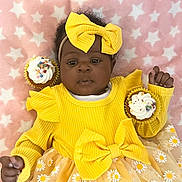 Omoize is registered to the contest to win money with this photo: baby, child, yellow_dress, bow, headband, cupcake, sprinkles, blanket, stars, pink_background, smiling, cute, infant, tutu_skirt, floral_pattern, celebration, sweet, happy, soft_texture, portrait