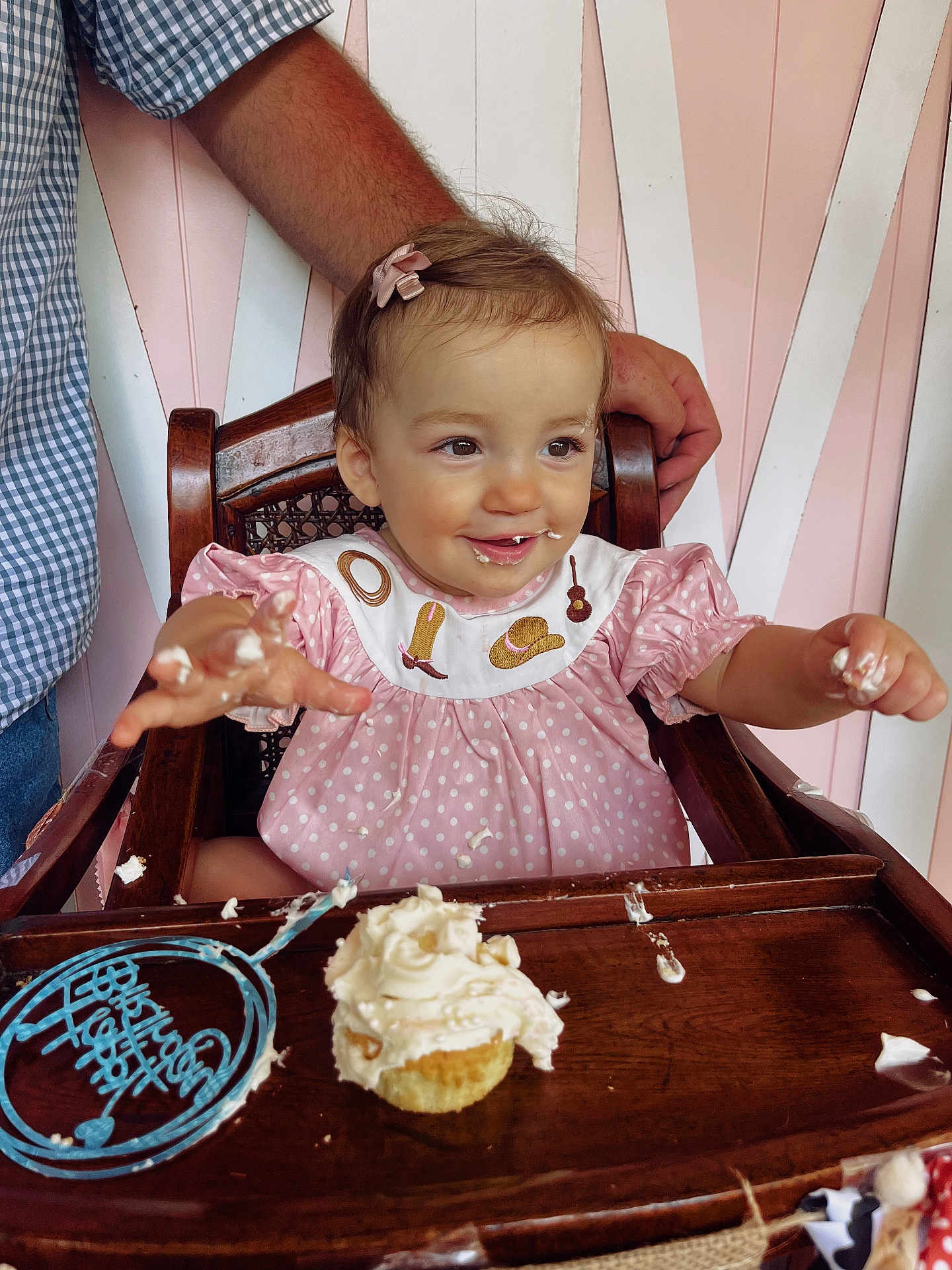 Sadie joined the competition — help win amazing prizes! toddler, child, cupcake, frosting, highchair, pink_dress, polka_dot, cream, smiling, happy, face, hands, arm, wood, chair, birthday, celebration, food, messy, indoor
