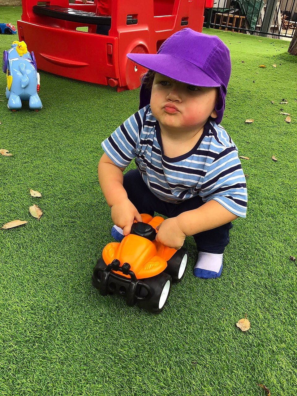 Thomas joined the competition — help win amazing prizes! bag, baseball_cap, cap, child, flooring, fun, grass, green, hat, headwear, lawn, leisure, luggage_and_bags, motor_vehicle, person, plant, recreation, sitting, toddler, toy