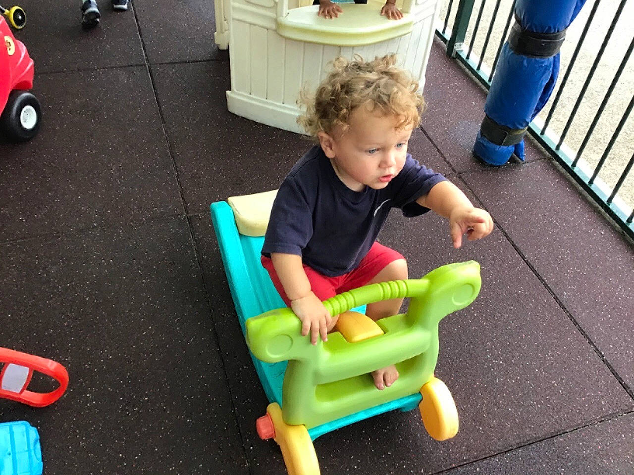 Thomas is registered to the contest to win money with this photo: baby, baby_playing_with_toys, baby_products, baby_toddler_clothing, child, flooring, fun, leisure, person, play, product, riding_toy, sitting, sneakers, t_shirt, tire, toddler, toy, toy_vehicle, wheel