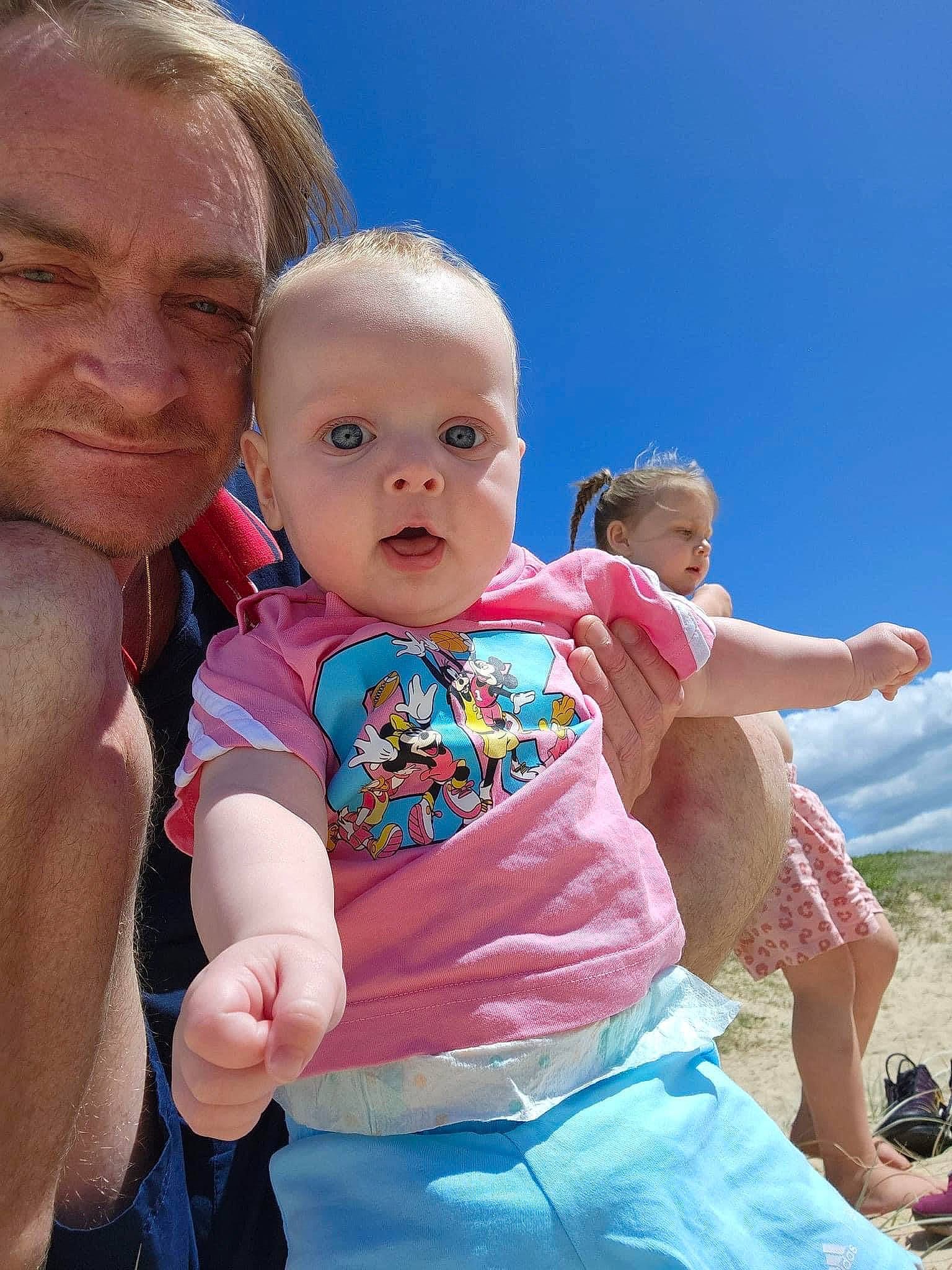 Ivy Mellissa joined the competition — help win amazing prizes! baby, baby_toddler_clothing, cheek, child, event, fun, gesture, grass, happy, human, interaction, leisure, people_in_nature, person, pink, recreation, sitting, skin, sky, t_shirt