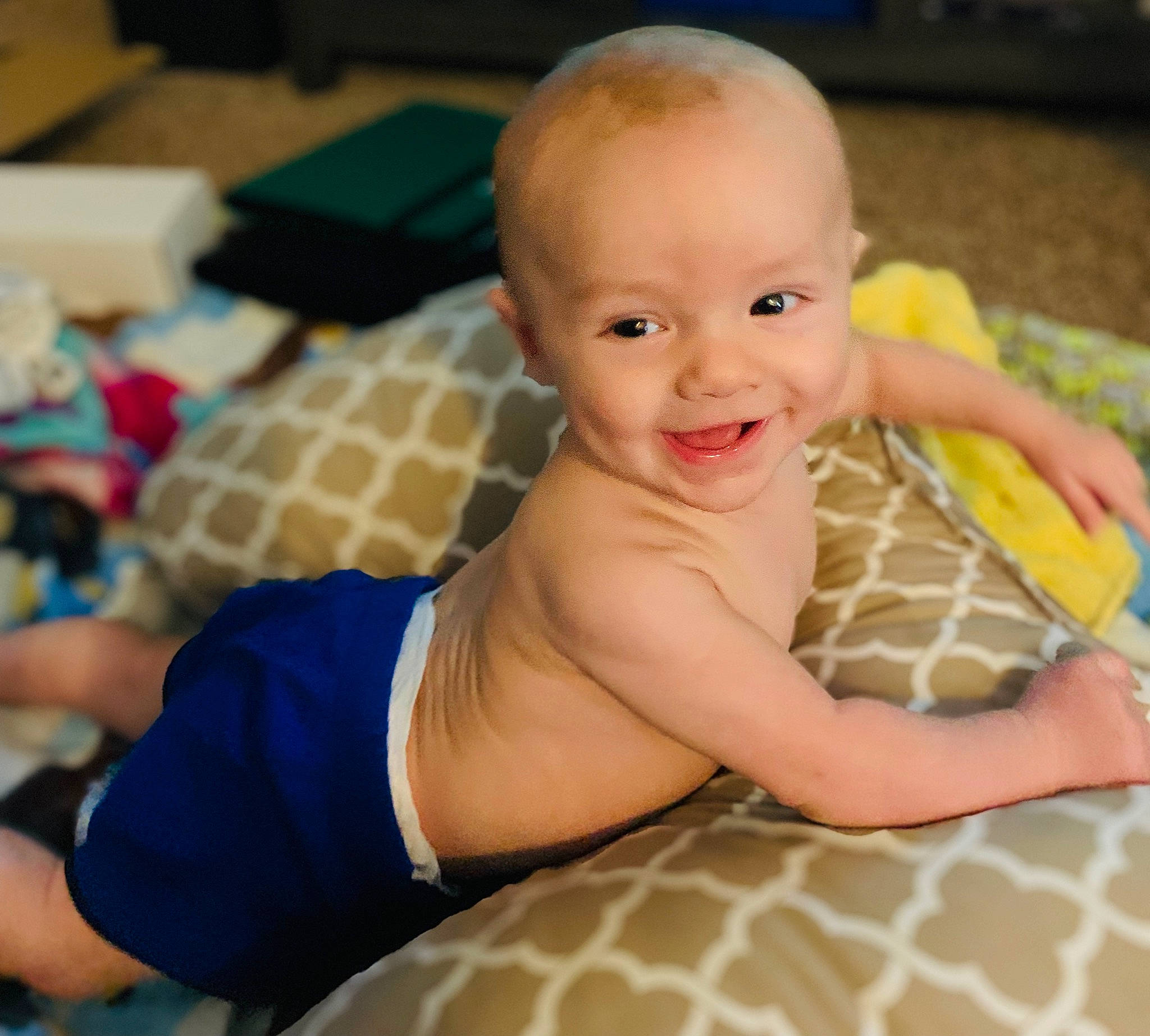 Anduin is registered to the contest to win money with this photo: baby, baby_playing_with_toys, cheek, chest, chin, finger, floor, flooring, fun, happy, joint, mouth, nose, person, skin, smile, thumb, toddler, toy, tummy_time