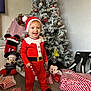 Jasper joined the competition — help win amazing prizes! toddler, child, christmas_tree, christmas_costume, santa_hat, candy_cane, holiday, decorations, plush_toy, mickey_mouse, gift_wrap, red_clothing, festive, smiling, indoor, carpet, present, celebration, happy, winter