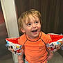 toddler, child, smiling, happy, swimwear, floaties, mickey_mouse, orange_shirt, colorful_shorts, indoor, wet_hair, playful, cute, portrait, person, fun, joyful, young_child, background, wood_panel