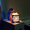 animal, blue_light, cabinet, cozy, curiosity, curious, decorative_lamp, feline, furniture, glow, indoor, kitten, lamp, light, night, pet, shadow, small_cat, soft_light, warm_light