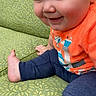 baby, child, infant, smiling, happy, sitting, portrait, face, eyes, bare_feet, orange_shirt, blue_pants, clothing, chair, upholstery, indoors, close_up, playful, cute, photography