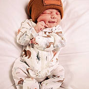 Harley joined the competition — help win amazing prizes! baby, newborn, sleeping, beanie, hat, onesie, animal_pattern, white_background, soft, cute, peaceful, infant, clothing, resting, child, portrait, cozy, small, smile, hand
