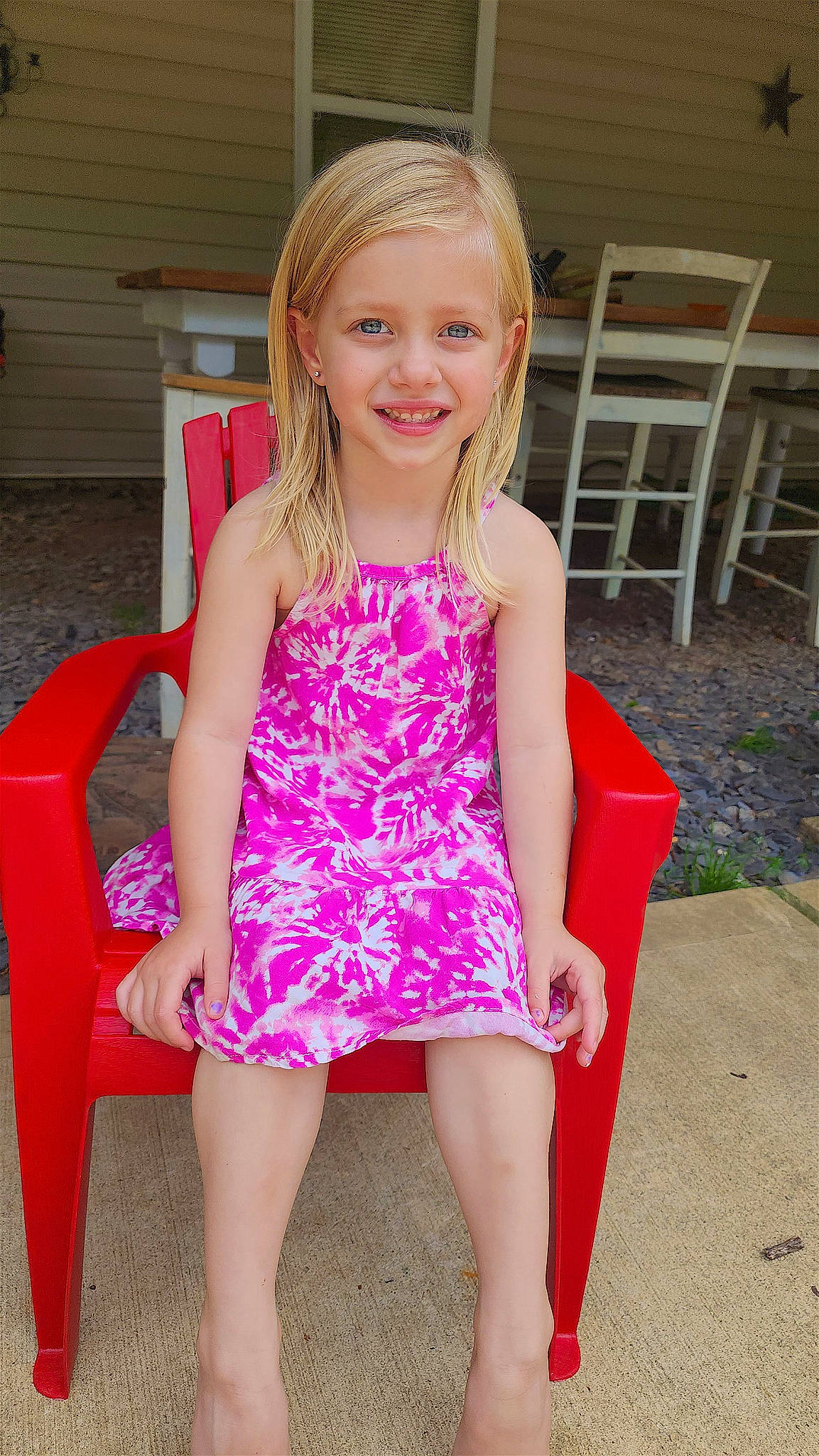 Abigail is registered to the contest to win money with this photo: chair, dress, face, fun, hair, happy, head, human_body, human_leg, joy, knee, long_hair, magenta, neck, pattern, person, pink, skin, smile, summer