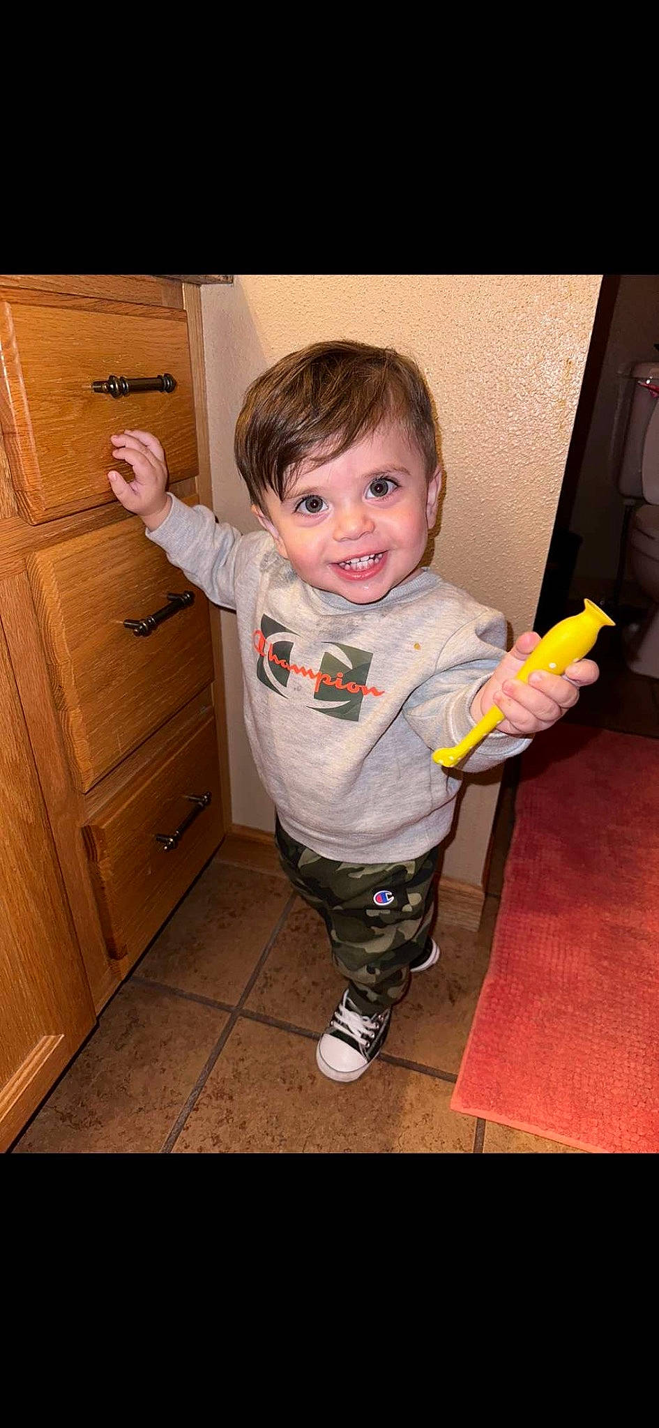 Ezekiel is registered to the contest to win money with this photo: baby, baby_toddler_clothing, cabinetry, cheek, child, drawer, eye, floor, flooring, gesture, happy, hardwood, joy, leg, nose, person, sleeve, smile, standing, thumb
