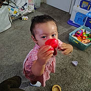 Gianna Renae Mcclure is registered to the contest to win money with this photo: toddler, child, toy, pink_dress, carpet, indoor, playtime, red_toy, face, hand, floor, furniture, storage_bin, clothing, person, young_child, home, play_kitchen, socks, curious