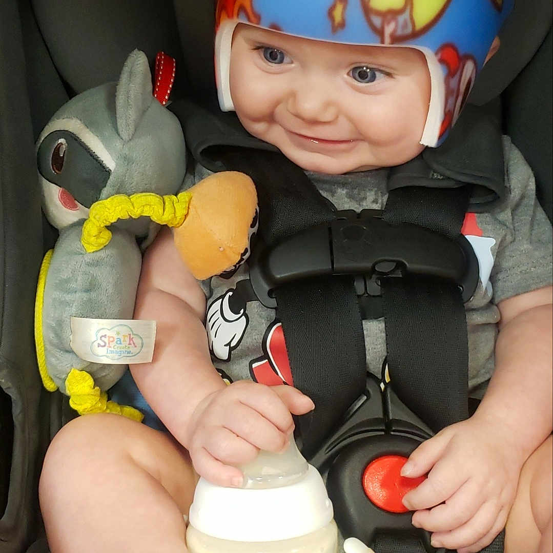 Grayson joined the competition — help win amazing prizes! baby, blue, bottle, car_seat, child, clothing, cute, face, foot, gray, hand, helmet, indoor, infant, plush_toy, safety, sitting, smiling, straps, toy