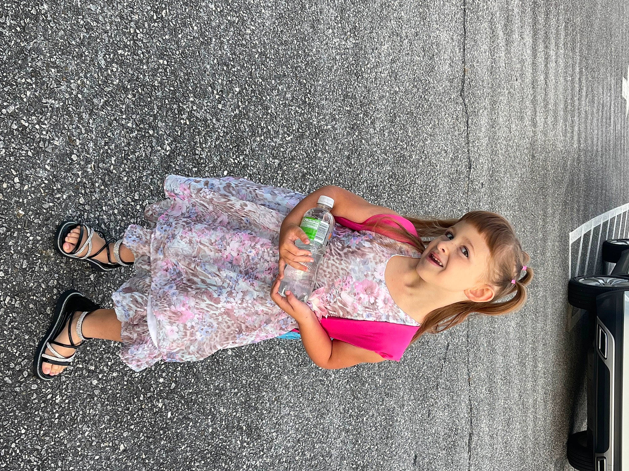 Khloe is registered to the contest to win money with this photo: child, comfort, foot, fun, grass, human_leg, joy, knee, leisure, magenta, nap, pattern, person, pink, road_surface, sandal, sidewalk, sitting, thigh