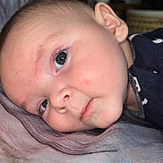 Edward joined the competition — help win amazing prizes! baby, blue_eyes, child, close_up, cute, ear, expression, eyelashes, face, head, indoors, infant, lying_down, mouth, nose, portrait, skin, sleepwear, soft_surface, young_child
