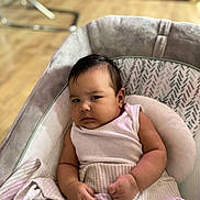 Lilibeth is registered to the contest to win money with this photo: baby, infant, blanket, cushion, seat, indoor, person, child, clothing, face, skin, arm, hand, expression, furniture, floor, wooden_floor, soft, resting, portrait