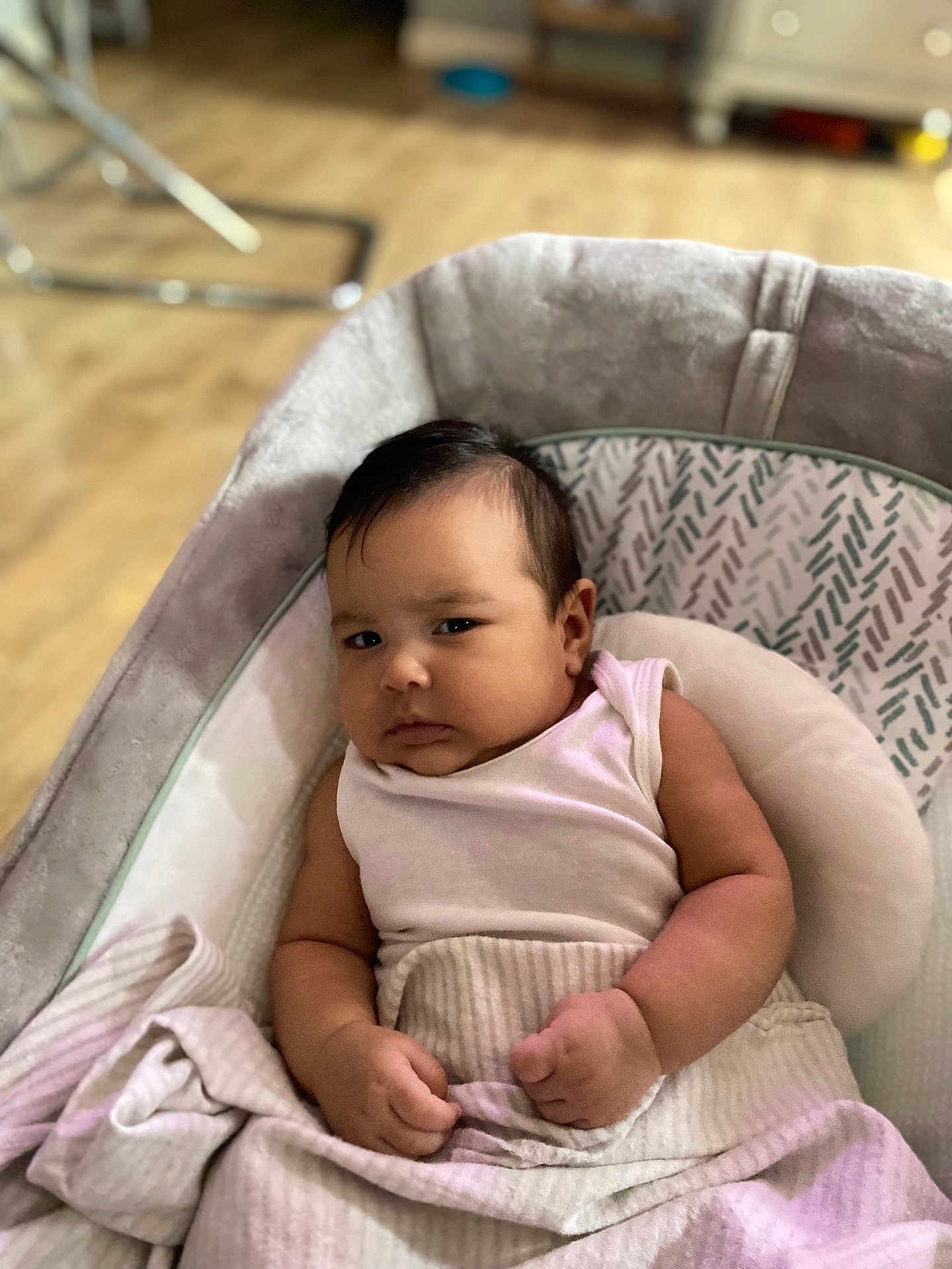 Lilibeth is registered to the contest to win money with this photo: baby, infant, blanket, cushion, seat, indoor, person, child, clothing, face, skin, arm, hand, expression, furniture, floor, wooden_floor, soft, resting, portrait