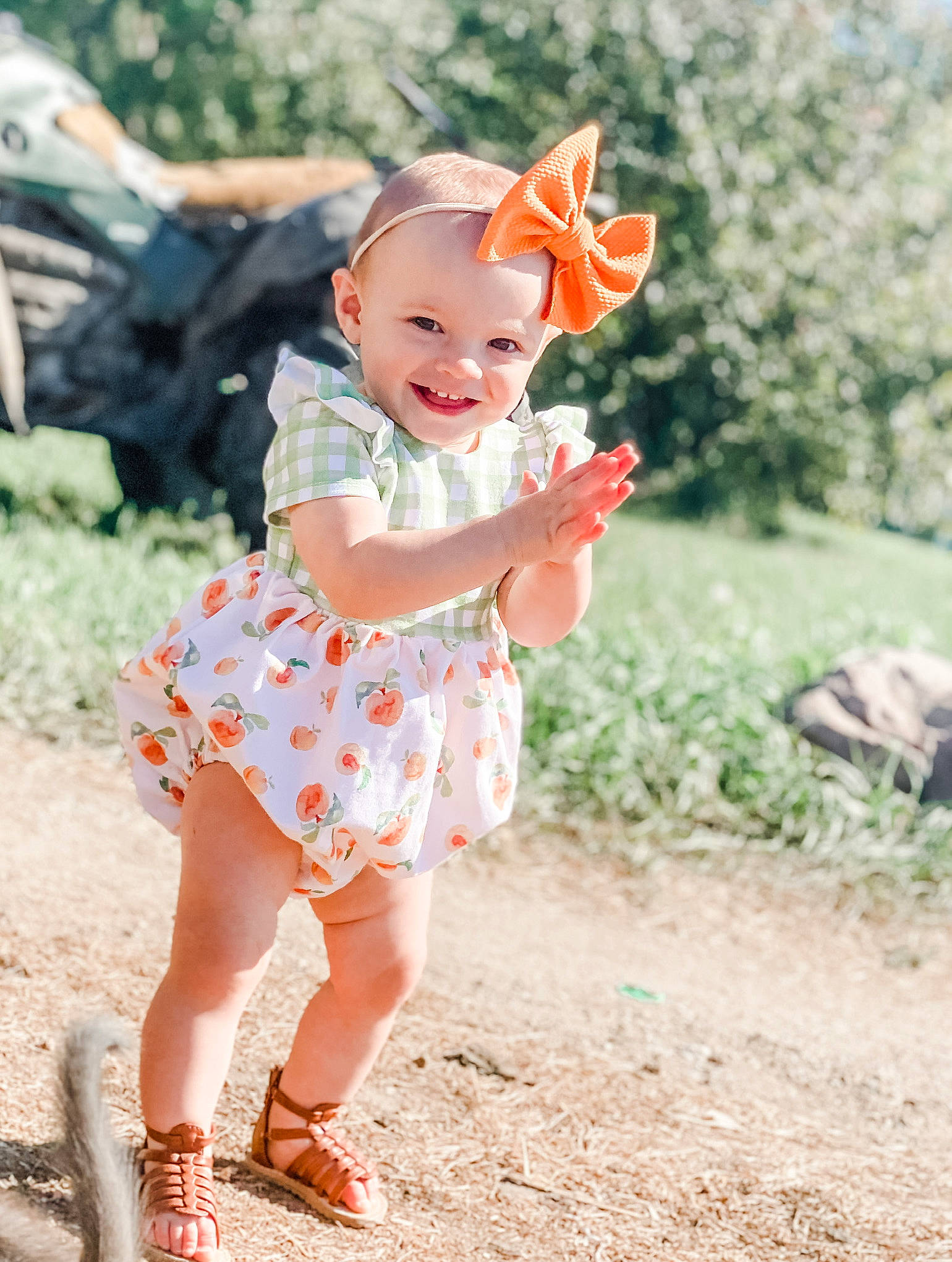 Roni is registered to the contest to win money with this photo: baby, baby_toddler_clothing, child, child_model, dress, fashion_accessory, headwear, joy, pattern, peach, person, photograph, photography, pink, plant, product, skin, smile, summer, textile