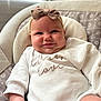 Emory is registered to the contest to win money with this photo: baby, bow, smile, infant, cushion, white_clothing, cozy, face, cheeks, headband, indoors, window_light, seat, cute, child, portrait, happy, soft, comfortable, relaxing