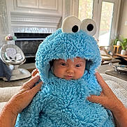 Luka joined the competition — help win amazing prizes! baby, child, costume, blue, fluffy, hood, eyes, hands, indoor, living_room, furniture, window, door, person, cute, soft, plush, expression, home, cozy