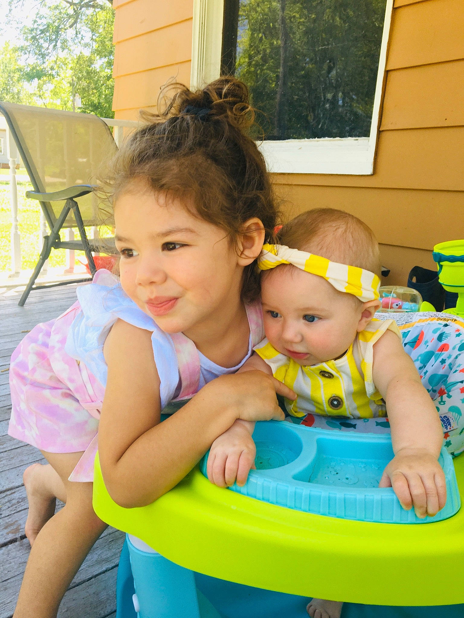 Celine is registered to the contest to win money with this photo: baby, baby_playing_with_toys, baby_toddler_clothing, chair, child, fun, grass, green, hairstyle, happy, headwear, joy, leisure, person, recreation, sharing, skin, smile, summer, toddler