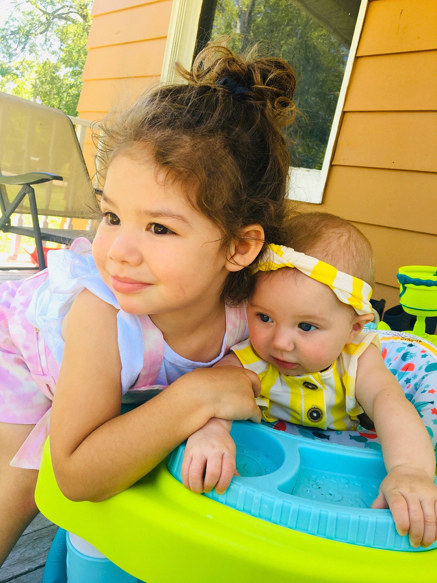 Celine is registered to the contest to win money with this photo: baby, baby_toddler_clothing, chair, child, clothing, event, facial_expression, fun, grass, green, hairstyle, happy, headwear, joy, leisure, person, pink, recreation, skin, smile