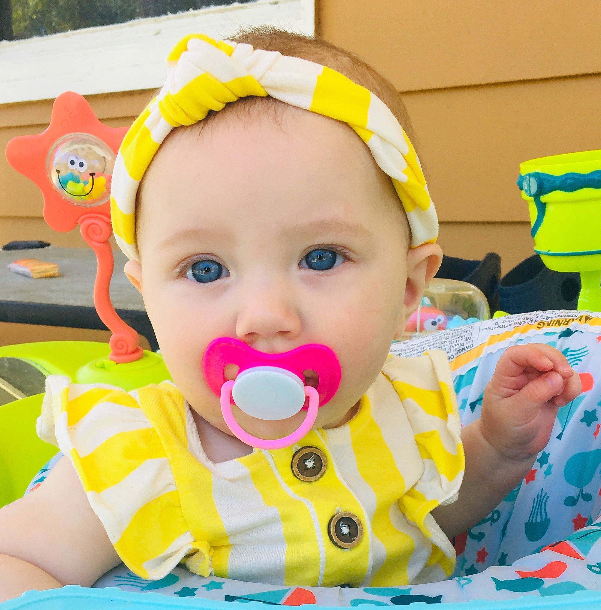 Lyla is registered to the contest to win money with this photo: baby, baby_playing_with_toys, baby_products, baby_toddler_clothing, baby_toys, cheek, child, eyelash, facial_expression, fun, green, happy, headband, party, party_supply, person, play, recreation, tableware, toddler