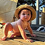 baby, child, hat, straw_hat, diaper, wooden_table, outdoor, sunlight, crawling, blue_eyes, face, person, summer, nature, wood, daylight, curious, cute, table, backyard