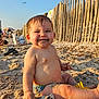 Castille participe au concours pour gagner de l'argent avec cette photo : baby, beach, sand, smile, happy, sunlight, fence, child, outdoor, summer, play, sand_toys, vacation, nature, person, fun, relaxation, barefoot, sunset, water