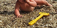 Castille participe au concours pour gagner de l'argent avec cette photo : baby, child, beach, sand, hat, toy, yellow, water, waves, curious, nature, outdoor, play, summer, crawling, exploring, sunhat, barefoot, rocky, shore