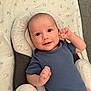 Brennus joined the competition — help win amazing prizes! baby, infant, onesie, blue_clothing, smile, face, head, hand, cushion, baby_seat, blanket, alphabet_pattern, indoor, child, person, cute, comfort, relaxing, happy, portrait