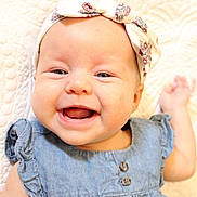 Daisy Mae joined the competition — help win amazing prizes! baby, smiling, headband, denim_dress, portrait, close_up, infant, happy, cute, child, face, skin, blue_eyes, textile, fabric, button, hand, blanket, soft, indoors