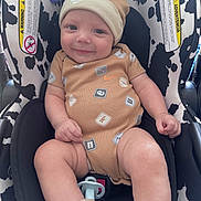 Dayden is registered to the contest to win money with this photo: baby, infant, smiling, car_seat, nike, hat, pacifier, clothing, cute, child, seatbelt, socks, indoor, person, happy, face, legs, hand, toy_clip, pattern