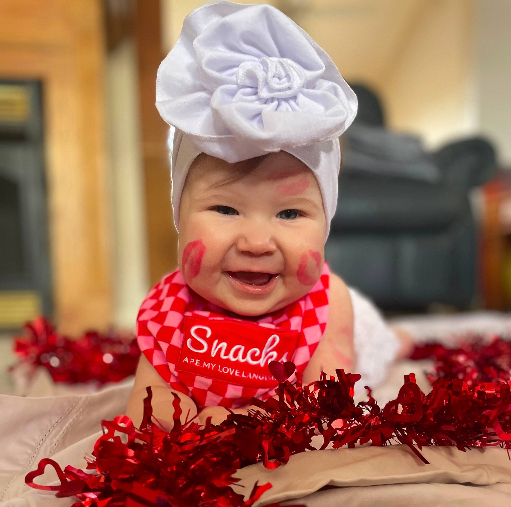 Justine is registered to the contest to win money with this photo: baby, baby_toddler_clothing, cap, carmine, child, costume_hat, event, face, fashion_accessory, font, fun, happy, hat, headwear, joy, person, petal, plant, red, smile