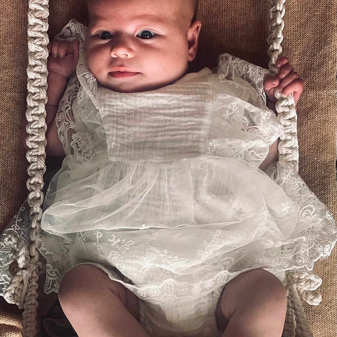 Jade participe au concours pour gagner de l'argent avec cette photo : baby, barefoot, child, closeup, cute, cute_face, fabric, feet, hands, indoors, infant, lace, legs, playful, portrait, rope, swing, texture, white_dress, wood