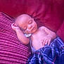 Tiberias is registered to the contest to win money with this photo: baby, sleeping, pacifier, blanket, couch, pillow, infant, child, peaceful, rest, indoor, comfort, relaxation, plaid, striped, soft_lighting, human, portrait, cozy, nap
