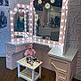 toddler, child, smiling, stool, vanity_mirror, lights, reflection, museum, mannequin, flooring, pink_clothing, patterned_pants, barefoot, wall_pattern, decor, happy, indoor, person, furniture, photography