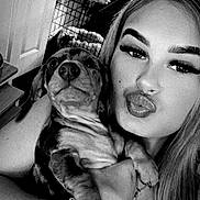 Minnie is registered to the contest to win money with this photo: black_and_white, bracelet, cabinet, cute, dog, dog_crate, face, furniture, happy, holding, indoor, long_hair, necklace, pet, plant, portrait, pucker_lips, puppy, selfie, woman