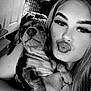 black_and_white, bracelet, cabinet, cute, dog, dog_crate, face, furniture, happy, holding, indoor, long_hair, necklace, pet, plant, portrait, pucker_lips, puppy, selfie, woman