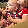 baby, toddler, child, cardboard_box, striped_clothing, red_clothing, carpet, backpack, indoor, hugging, cute, curious, portrait, blue_eyes, light_hair, sitting, closeup, happy, family, playful