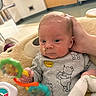 Anthony joined the competition — help win amazing prizes! baby, blanket, child, clothing, cushion, cute, face, floor, furniture, hand, head, hospital, indoor, infant, nasal_tube, onesie, person, plush, rattle, toy