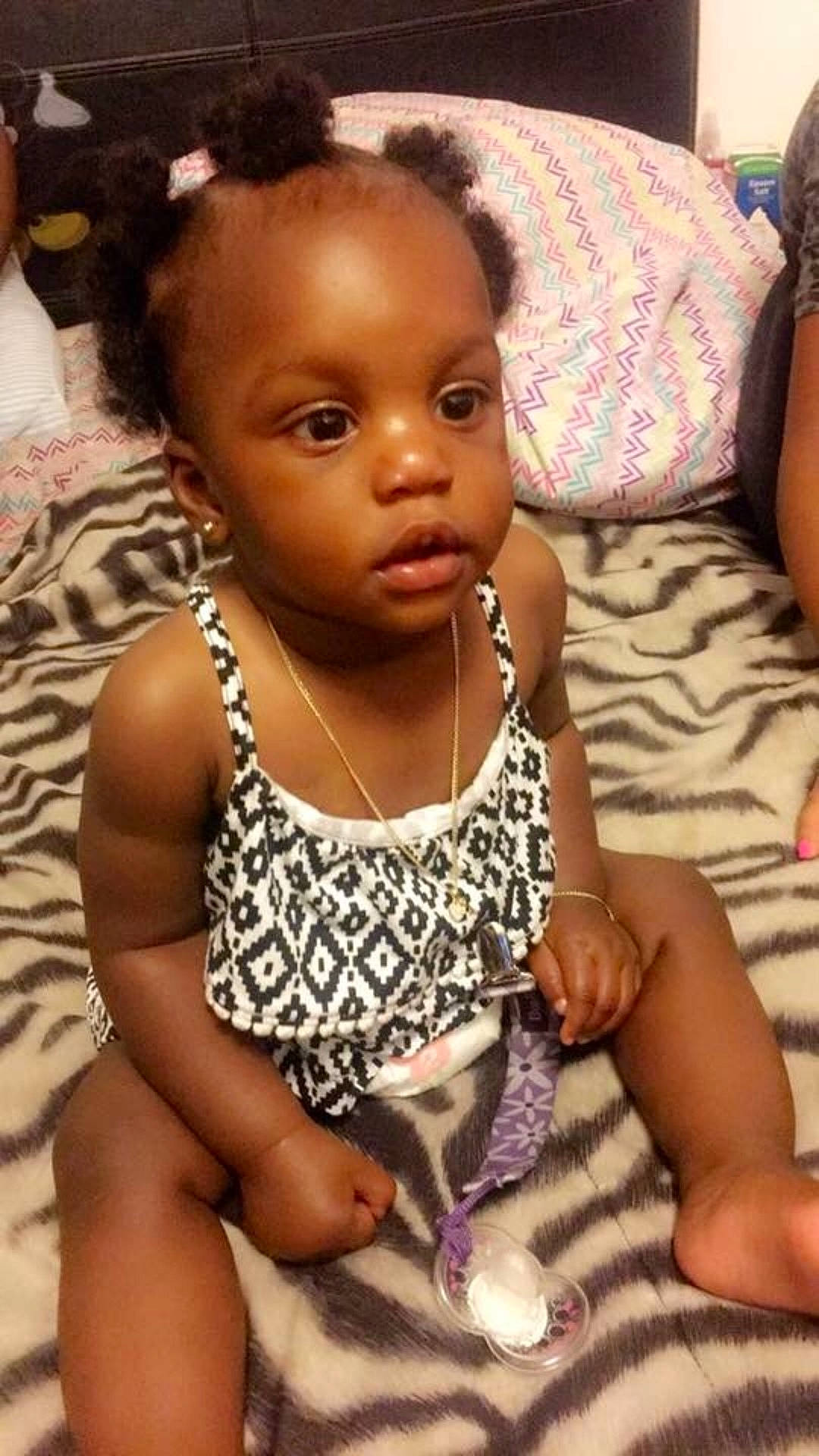 Serenity is registered to the contest to win money with this photo: abdomen, arm, black_hair, cheek, child, day, face, finger, girl, hair, hairstyle, head, human_hair_color, infant, person, product, sitting, skin, toddler, trunk