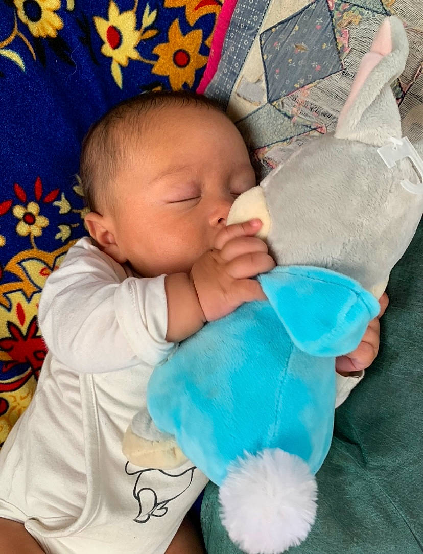 Léyan participe au concours pour gagner de l'argent avec cette photo : aqua, azure, baby, baby_sleeping, baby_toddler_clothing, blue, child, comfort, finger, gesture, hand, linens, mammal, person, pink, product, skin, sleeve, textile, toddler