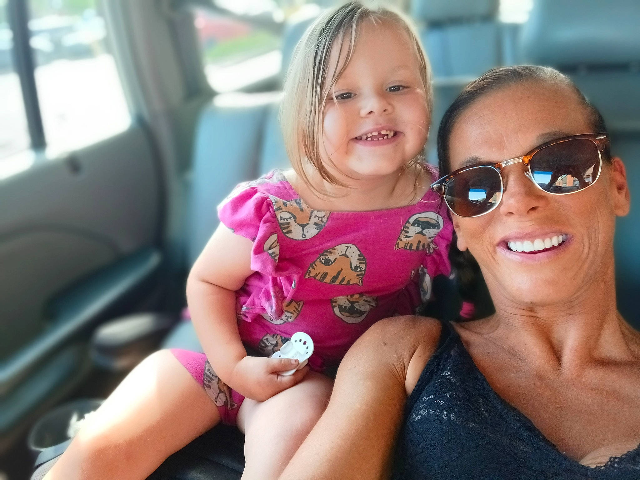 Isabella is registered to the contest to win money with this photo: arm, blond, child, cool, dress, face, fun, glasses, goggles, hand, happy, joy, leisure, lip, person, pink, plant, skin, smile, sunglasses