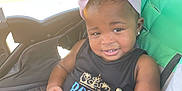 Blessing is registered to the contest to win money with this photo: baby, black_tank_top, child, colorful_clothing, cute, daylight, earrings, fashion, happy, headband, infant, outdoor, pigtails, portrait, railroad_tracks, seat, sitting, smile, stroller, toddler