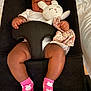 baby, infant, sleeping, plush_toy, bunny, pink_socks, baby_seat, black_fabric, cute, child, soft_toy, hand, footwear, legs, relaxation, indoors, comfort, rest, toddler, sleep